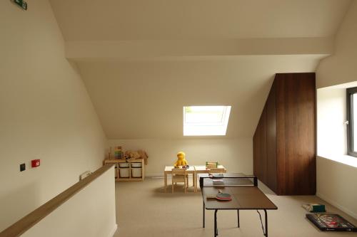 a living room with a table and a chair at La Barzalière in Chimay