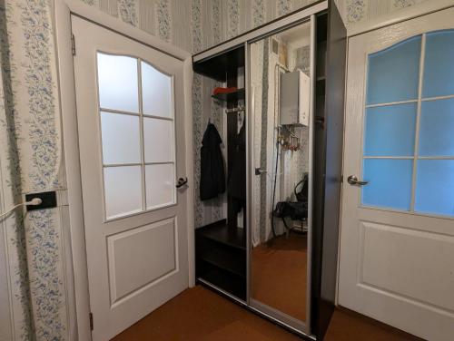 a hallway with a door and a walk in closet at Квартира в колоритном одесском дворе - Authentic Odesa Apartment in Odesa