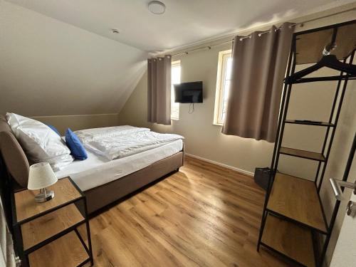 a small bedroom with a bed and a ladder at Feriendomizil im Saarschleifenland in Mettlach