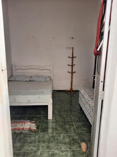 a room with two beds and a tiled floor at Paracuru HolaOnda WaveHostel in Paracuru