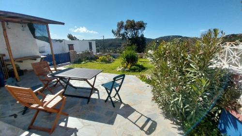 a patio with a table and chairs on a patio at Clive and Bifi's house in Lachania