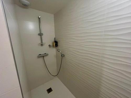 La salle de bains est pourvue d'une cabine de douche avec un tuyau. dans l'établissement Appartement avec terrasse, 2 chambres, proche plage - 4 pers - FR-1-494-198, à Royan