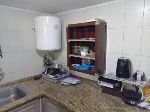 a kitchen with a sink and a mixer on a counter at Sky2 in Jerash