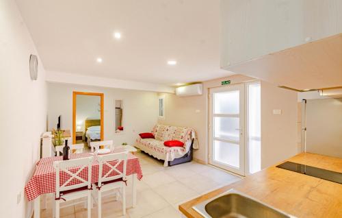 a kitchen and living room with a couch and a sink at Apartman Jagoda - Vela Luka by Villas Guide in Vela Luka