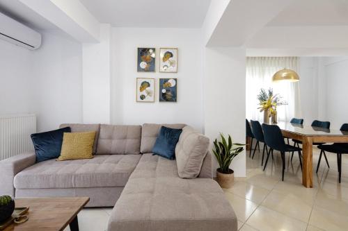 a living room with a couch and a table at Private Rooftop Jacuzzi Sea View Walk to Beach in Rethymno