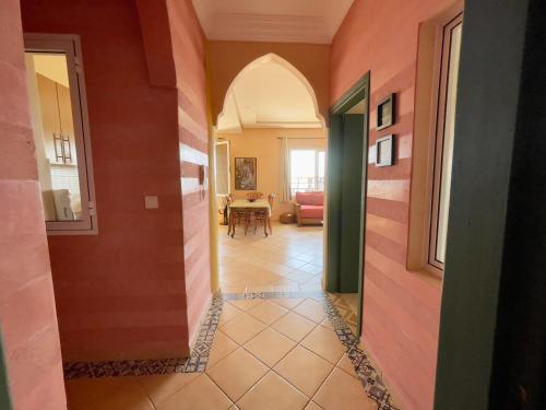 a hallway of a house with a room with a table at A7 Maison Blanche Imi ouaddar in Agadir