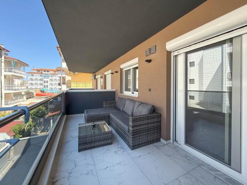 a balcony with a couch and a table at Ilektra Suites by SDR in Paralia Katerinis