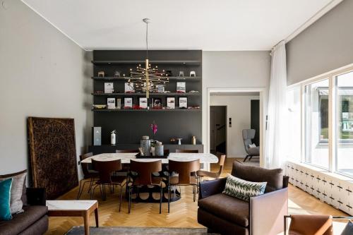 a living room with a table and chairs at Luxurious family villa in a unique location in Djursholm