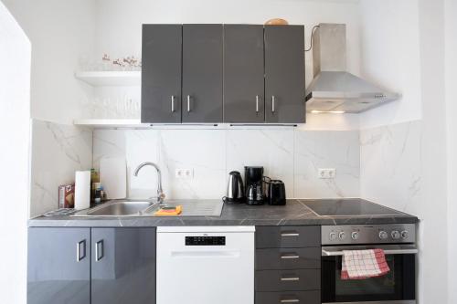 a kitchen with a sink and a stove and cabinets at Zw -Maria Laach und Nürburgring in Mayen