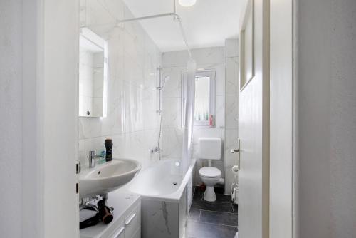 a white bathroom with a sink and a toilet at Zw -Maria Laach und Nürburgring in Mayen