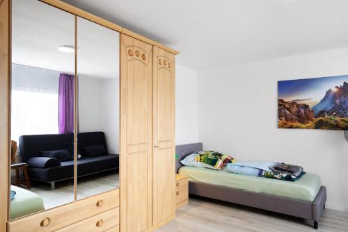 a bedroom with a large wooden cabinet and a bed at Zw -Maria Laach und Nürburgring in Mayen