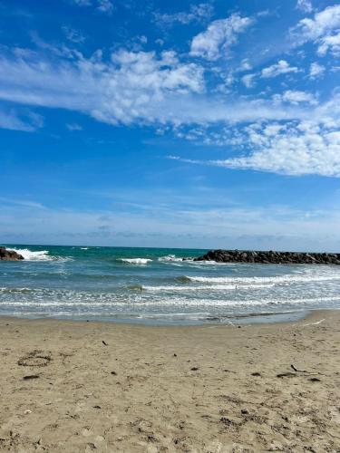 a beach with the ocean and rocks in the background at SOLEA Frontignan Plage in Frontignan