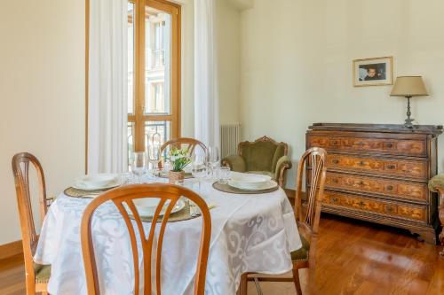 a dining room with a table and chairs and a dresser at Casa MAMMA in Lovere