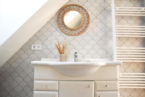 a bathroom with a sink and a mirror at Iluska Vendégház in Mátraszentimre