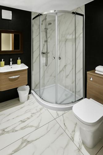 a bathroom with a shower and a toilet and a sink at Morpeth City Centre Apartment in Morpeth