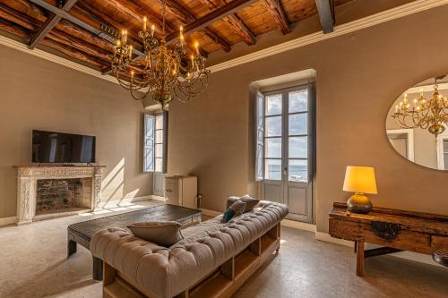 a living room with a couch and a chandelier at Saint Amand by Palazzo Boyl in Cagliari