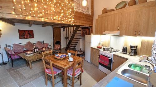 a kitchen with a table and a dining room at Popi Studio 1 Mochos Square in Mokhós