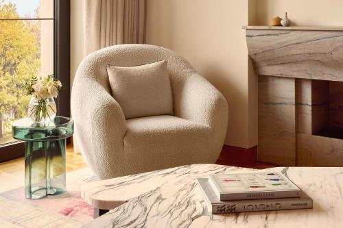 a living room with a chair and a table at The Berkeley, Maybourne in London