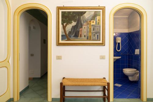 a bathroom with a toilet and a picture on the wall at Sea Soul Positano in Positano