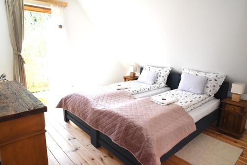a bedroom with a bed and a window at Iluska Vendégház in Mátraszentimre