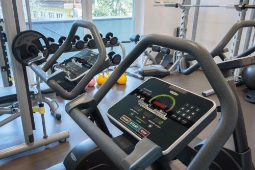 a gym with several tread machines and a simulator at Sport Chalet Maria Alm in Maria Alm am Steinernen Meer