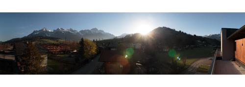 a view of the sun shining on a mountain at Sport Chalet Maria Alm in Maria Alm am Steinernen Meer