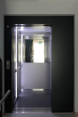 an open door to a bathroom with a mirror at Sport Chalet Maria Alm in Maria Alm am Steinernen Meer