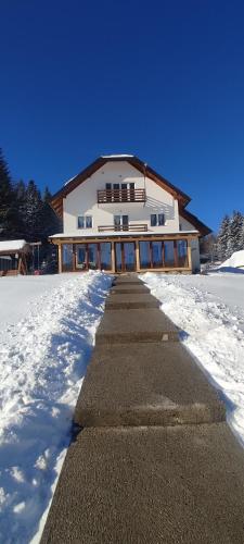 a building with snow in front of it at Nikolića kuća in Mitrovac