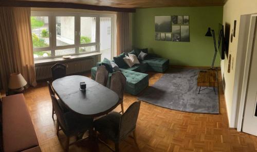 a living room with a table and a couch at Ferienwohnung Stadthaus Cham in Cham