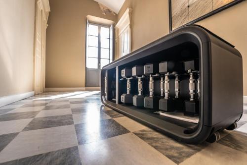 a wine display in a room with a checkered floor at Saint Amand by Palazzo Boyl in Cagliari
