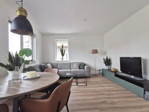 a living room with a table and a couch at Cornfield in Arnhem