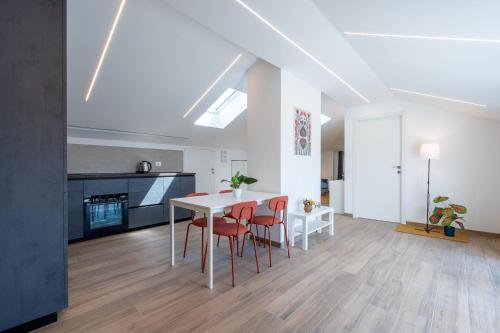 a kitchen and dining room with a table and chairs at La tana dei sogni in Chieri