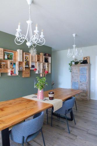a dining room with a wooden table and blue chairs at Bed and Breakfast Le Giale in Castelnuovo del Garda