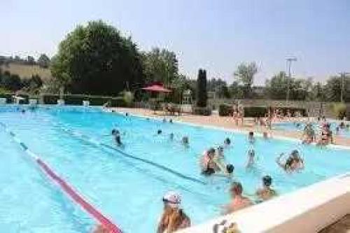 a group of people in a swimming pool at Camping de Charlieu in Charlieu