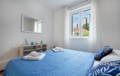 a bedroom with a blue bed and a window at Apartman Marija Slano by Villas Guide in Slano