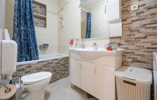 a bathroom with a toilet and a sink and a tub at Apartman Marija Slano by Villas Guide in Slano