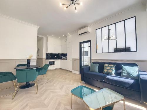 un salon avec un canapé bleu et une table dans l'établissement Nestor&Jeeves - EMERAUDE - Central - Modern, à Nice