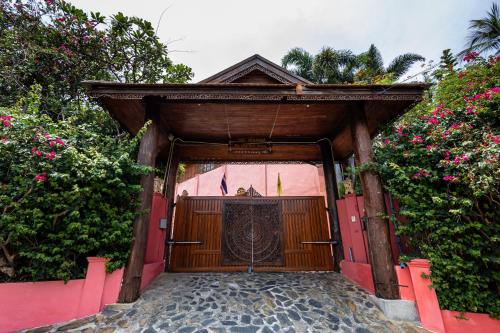 an entrance to a wooden gate to a building at Luxury Villa Miramar Orchid House Samui in Amphoe Koh Samui