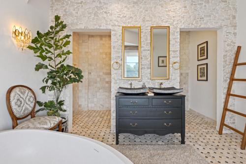 a bathroom with a black dresser and a mirror at Luxurious Arakana Villa with Pool in Jimbaran