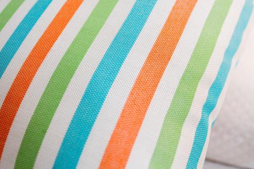 a close up of a colorful striped pillow at Apartamentos Pou Des Pujols in Es Pujols