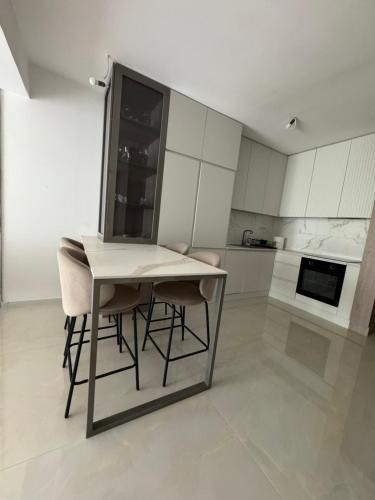 a kitchen with a table and chairs in a room at Royal Apartments in Skopje