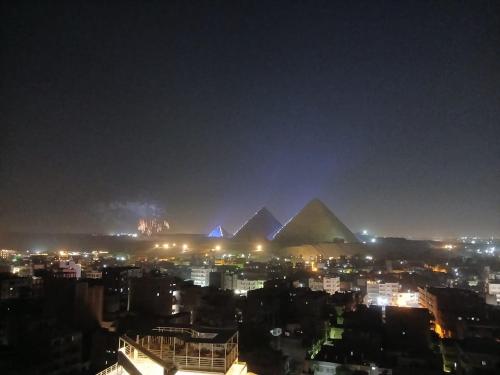 a view of the pyramids of giza at night at ALADDIN PYRAMIDS View in Cairo