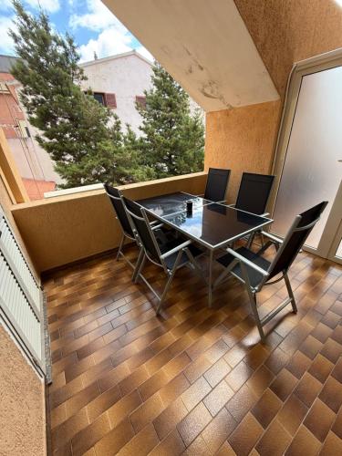 a balcony with a table and chairs on it at B&B Arcipelago in La Maddalena