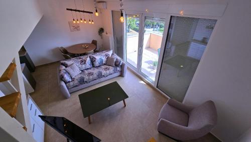a living room with a couch and a table at Apartments Danica in Petrovac na Moru