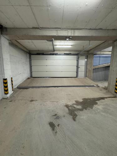 an empty garage with white garage doors in a building at Royal Apartments in Skopje