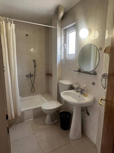 a bathroom with a toilet and a sink and a shower at Better place in Becici
