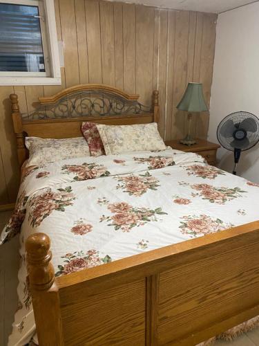 a bedroom with a bed with a floral bedspread at Peace and Comfort 1-bedroom basement Apartment in Brampton