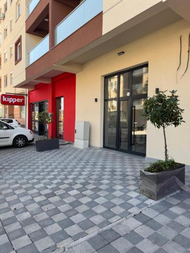 a building with a tree in front of it at Royal Apartments in Skopje