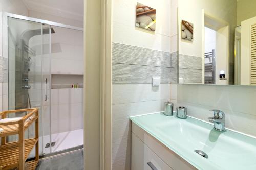 a bathroom with a sink and a shower at Beco dos Inválidos 67 Apartments in Cascais
