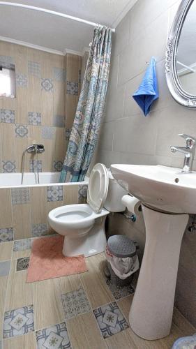 a bathroom with a toilet and a sink at Popi Studio 2, Mochos Square in Mokhós